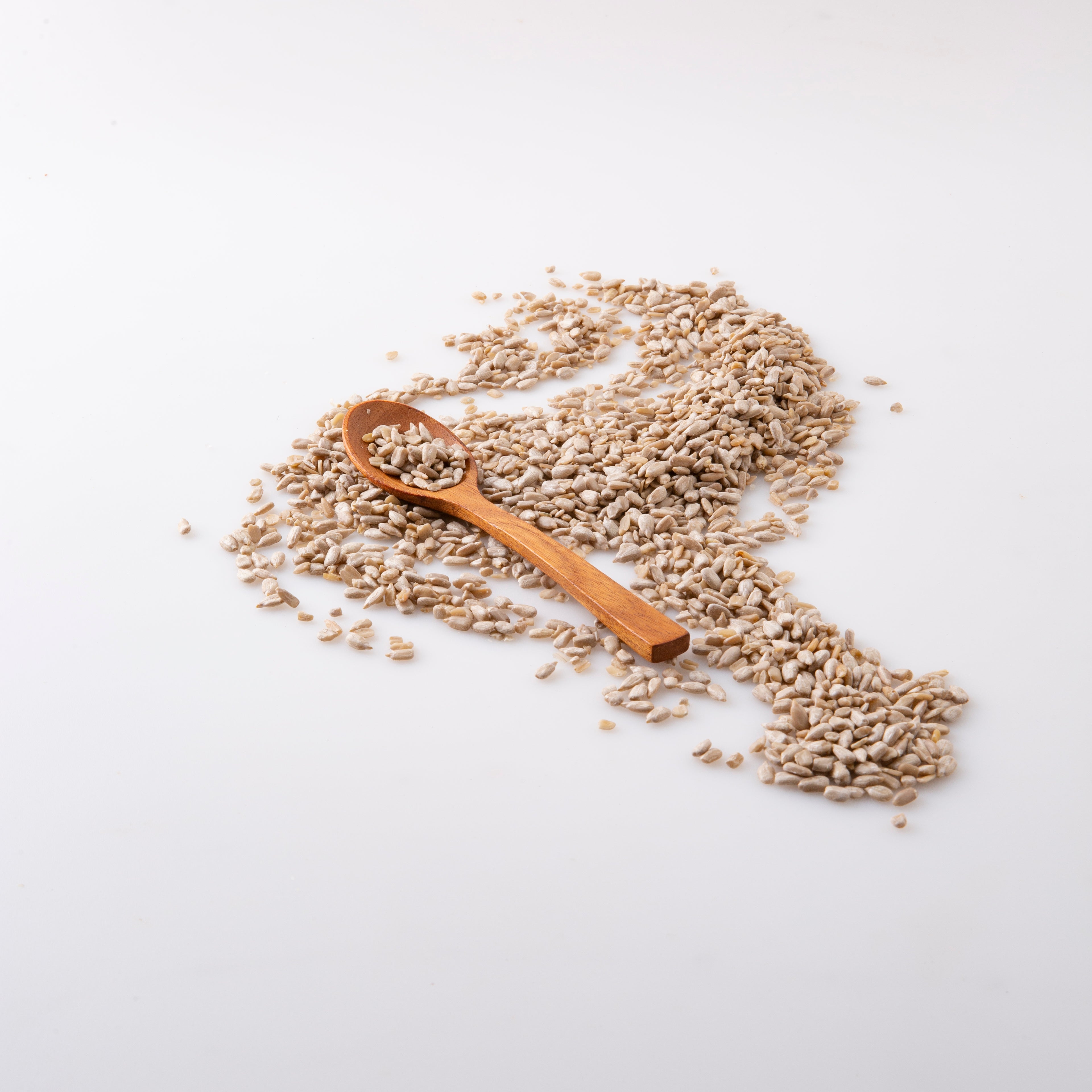 An image of Organic Sunflower Seeds (Seeds) on wooden spoon - Naked Foods