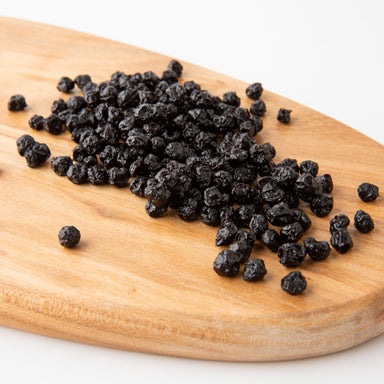 Organic Dried Blueberries (Dried Fruits) on wooden serving board - Naked Foods