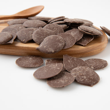 Milk Carob Buttons (Carob) on wooden serving board - Naked Foods