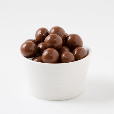 Milk Chocolate Macadamias (Chocolates) when served in white bowl - Naked Foods