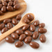 A photo of Milk Chocolate Almonds (Chocolates) on wooden spoon - Naked Foods