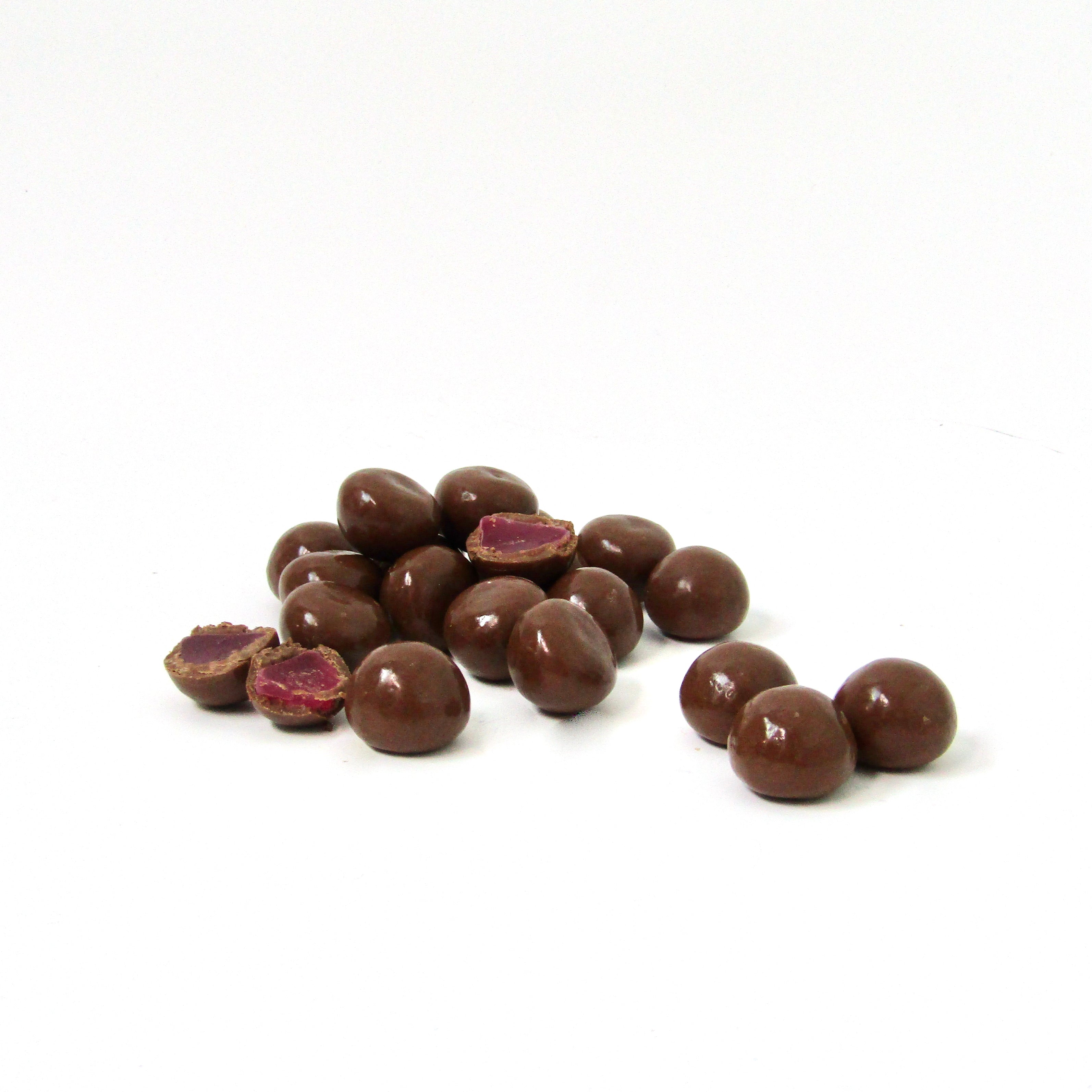 An image of sweet and chewy gummy raspberries coated in creamy milk chocolate - Naked Foods